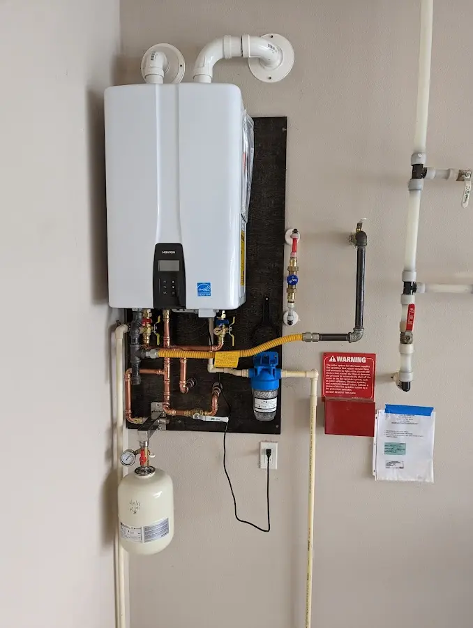 Professional plumber installing copper piping in a Avondale home